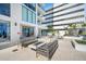 Chic outdoor patio featuring modern seating, a fire pit, barbecue area, and manicured landscaping at 301 1St S St # 1906, St Petersburg, FL 33701