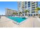 Gorgeous outdoor pool area with lounge chairs, palm trees, and a stunning high-rise building backdrop at 301 1St S St # 1906, St Petersburg, FL 33701