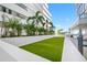 Building exterior showing turf with blue sky and palm trees at 301 1St S St # 1906, St Petersburg, FL 33701