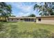A large backyard with a covered patio provides a serene outdoor living space at 321 Belle View Ave, Temple Terrace, FL 33617