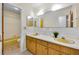 Bathroom featuring double vanity with yellow sinks, large mirrors, and bright lighting at 321 Belle View Ave, Temple Terrace, FL 33617