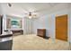 Bedroom featuring a neutral carpet, ceiling fan, window, closet and wood dresser at 321 Belle View Ave, Temple Terrace, FL 33617