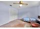 Cozy bedroom with light blue walls, a ceiling fan, and double closet at 321 Belle View Ave, Temple Terrace, FL 33617