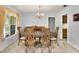 Spacious dining room boasts a chandelier and large window with natural light at 321 Belle View Ave, Temple Terrace, FL 33617