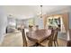 Dining room with chandelier is conveniently located between two separate living areas at 321 Belle View Ave, Temple Terrace, FL 33617