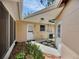 View of back patio area with brick pavers and two doors at 321 Belle View Ave, Temple Terrace, FL 33617