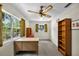 Home office with large window, bookshelf, desk and ceiling fan at 321 Belle View Ave, Temple Terrace, FL 33617