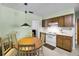 Eat-in kitchen features an oval wooden table, chairs, and white appliances at 321 Belle View Ave, Temple Terrace, FL 33617