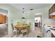 This eat-in kitchen opens to another room with a dining table and chandelier at 321 Belle View Ave, Temple Terrace, FL 33617