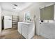 Functional laundry room includes a washer, dryer, shelving, and an exterior door for convenience at 321 Belle View Ave, Temple Terrace, FL 33617
