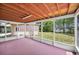 Relaxing screened porch with a pink floor offers an ideal space for outdoor enjoyment at 321 Belle View Ave, Temple Terrace, FL 33617