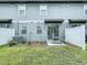 Outdoor patio with seating, a well-maintained lawn, and a partial view of the backyard space at 32451 Limitless Pl, Wesley Chapel, FL 33545
