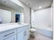 Bathroom with a white vanity, neutral walls, and tile floors with tub/shower combo at 32451 Limitless Pl, Wesley Chapel, FL 33545