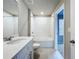 Bright bathroom featuring a tub/shower combo, white vanity, and tile flooring at 32451 Limitless Pl, Wesley Chapel, FL 33545