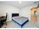 Bedroom with a modern bed frame and gray carpet flooring, creating a cozy and stylish space at 32451 Limitless Pl, Wesley Chapel, FL 33545