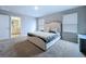 Bedroom with carpet flooring, and neutral walls with a walk-in bathroom for a luxurious feel at 32451 Limitless Pl, Wesley Chapel, FL 33545