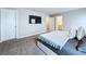 Bedroom with carpet flooring, neutral walls, and a TV mounted in the wall at 32451 Limitless Pl, Wesley Chapel, FL 33545