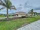 Stone monument sign for Watergrass Towns community, landscaped with palms and green grass at 32451 Limitless Pl, Wesley Chapel, FL 33545
