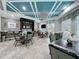 This inviting dining area features a stylish coffered ceiling, a modern light fixture, and a convenient bar area at 32451 Limitless Pl, Wesley Chapel, FL 33545