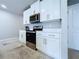 Kitchen featuring white cabinets and modern appliances in open layout, great for entertaining Gathering and friends at 32451 Limitless Pl, Wesley Chapel, FL 33545