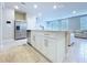 Bright kitchen island with stainless steel appliances and open to the living space with lots of light at 32451 Limitless Pl, Wesley Chapel, FL 33545