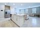 Bright kitchen with island, stainless steel appliances, and an open-concept layout into the living area at 32451 Limitless Pl, Wesley Chapel, FL 33545