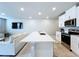 Modern kitchen featuring a large island, stainless steel appliances, and an open layout to the living area at 32451 Limitless Pl, Wesley Chapel, FL 33545