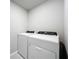 Efficient laundry room featuring a modern washer and dryer set against neutral walls at 32451 Limitless Pl, Wesley Chapel, FL 33545