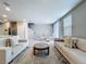 Bright open-concept living room and dining area, featuring modern decor and stainless steel kitchen appliances at 32451 Limitless Pl, Wesley Chapel, FL 33545