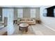 Living room featuring lots of natural light, tile floors, and comfortable seating area at 32451 Limitless Pl, Wesley Chapel, FL 33545