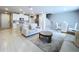Bright open-concept living room and kitchen featuring stainless steel appliances, tile flooring, and modern furnishings at 32451 Limitless Pl, Wesley Chapel, FL 33545