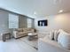 Comfortable living room featuring lots of natural light, tile floors, and flat screen TV at 32451 Limitless Pl, Wesley Chapel, FL 33545