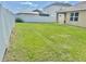 Lush backyard, featuring a white vinyl fence and manicured lawn at 3313 San Moise Pl, Plant City, FL 33567