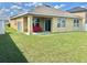 Expansive backyard with lush green grass, covered patio, and privacy fence at 3313 San Moise Pl, Plant City, FL 33567