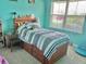 Well-lit bedroom featuring a window and a bed with storage drawers at 3313 San Moise Pl, Plant City, FL 33567