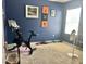 Bedroom showing exercise equipment and personal touches against blue wall at 3313 San Moise Pl, Plant City, FL 33567