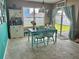Bright dining area with a cute wooden table, and light-filled with sliding glass doors to the back at 3313 San Moise Pl, Plant City, FL 33567