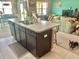 Kitchen island overlooks the dining and living rooms in an open floor plan layout at 3313 San Moise Pl, Plant City, FL 33567