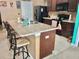 Kitchen island features a large countertop, sink, and bar seating for a modern design at 3313 San Moise Pl, Plant City, FL 33567