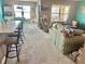 Bright and airy living room featuring large windows and neutral carpeting with a cozy sofa and recliner at 3313 San Moise Pl, Plant City, FL 33567