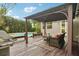 Cozy backyard deck with seating and outdoor grill and an in-ground swimming pool in the background at 333 30Th N Ave, St Petersburg, FL 33704