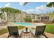 Backyard pool with an adjacent deck, lounge chairs, well-manicured landscaping, and the home's exterior at 333 30Th N Ave, St Petersburg, FL 33704