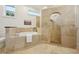 Tiled bathroom featuring a soaking tub, shower with glass surround, and toilet at 333 30Th N Ave, St Petersburg, FL 33704