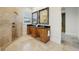 Bathroom with dual sinks, a glass shower, and travertine tile at 333 30Th N Ave, St Petersburg, FL 33704