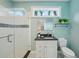 Bright bathroom with light blue walls, granite counters, a glass shower and transom window at 333 30Th N Ave, St Petersburg, FL 33704