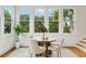 Cozy breakfast nook featuring a round table, four chairs, and large windows overlooking the landscaped outdoors at 333 30Th N Ave, St Petersburg, FL 33704