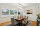 Formal dining room with a rectangular table, seating, decorative lighting, and a large window with shutter blinds at 333 30Th N Ave, St Petersburg, FL 33704