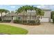 Charming home with lush landscaping, mature palms, and a well-manicured lawn at 333 30Th N Ave, St Petersburg, FL 33704