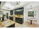 Bright kitchen showcasing dark cabinets, granite countertops, stainless steel appliances, and tile flooring at 333 30Th N Ave, St Petersburg, FL 33704
