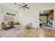 Bright living room with neutral tones, ceiling fan, and an open doorway to the garage with laundry at 333 30Th N Ave, St Petersburg, FL 33704